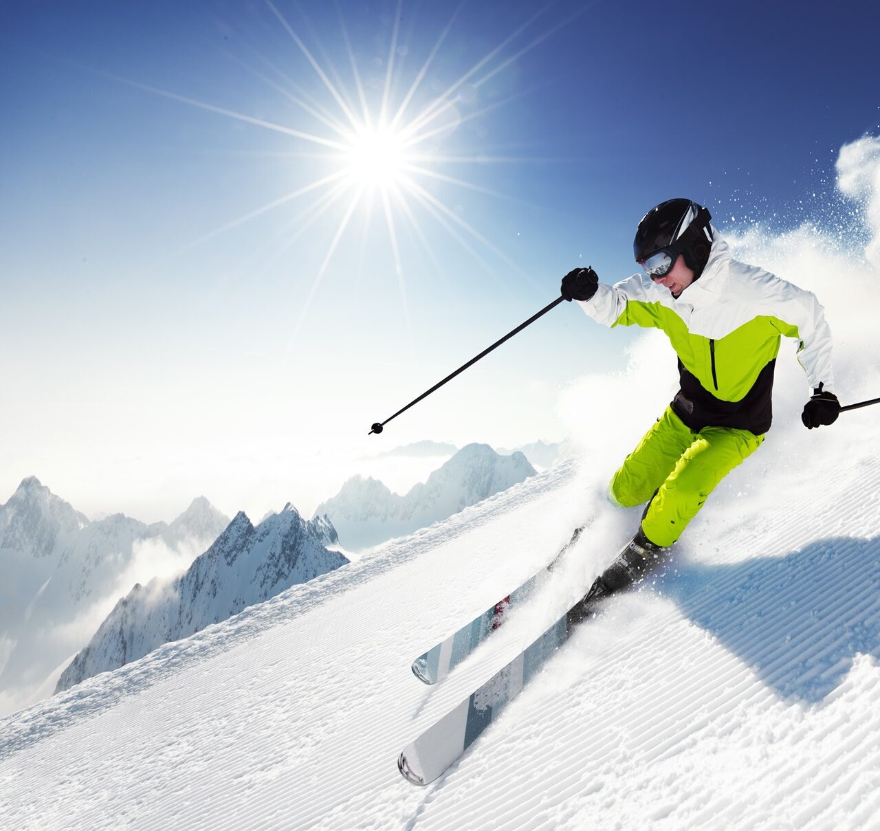 Skier in mountains, prepared piste and sunny day